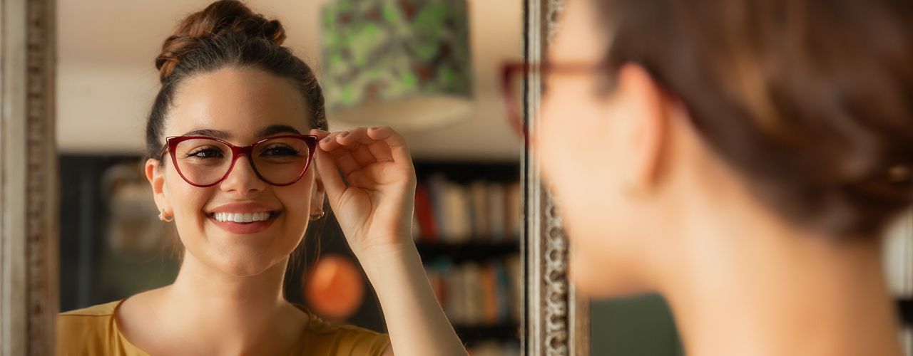 Woman trying on a pair of glasses from her home trial box